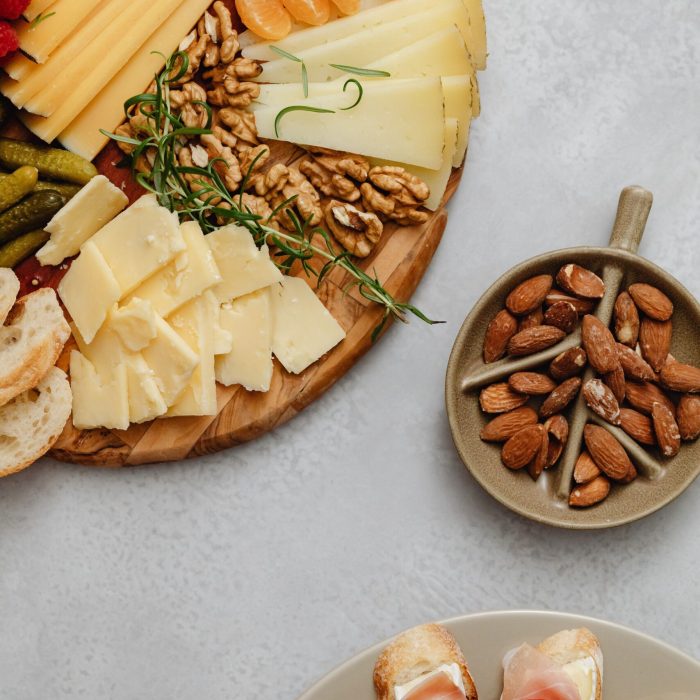 A gourmet selection of cheeses, fruits, and nuts on a charcuterie platter.